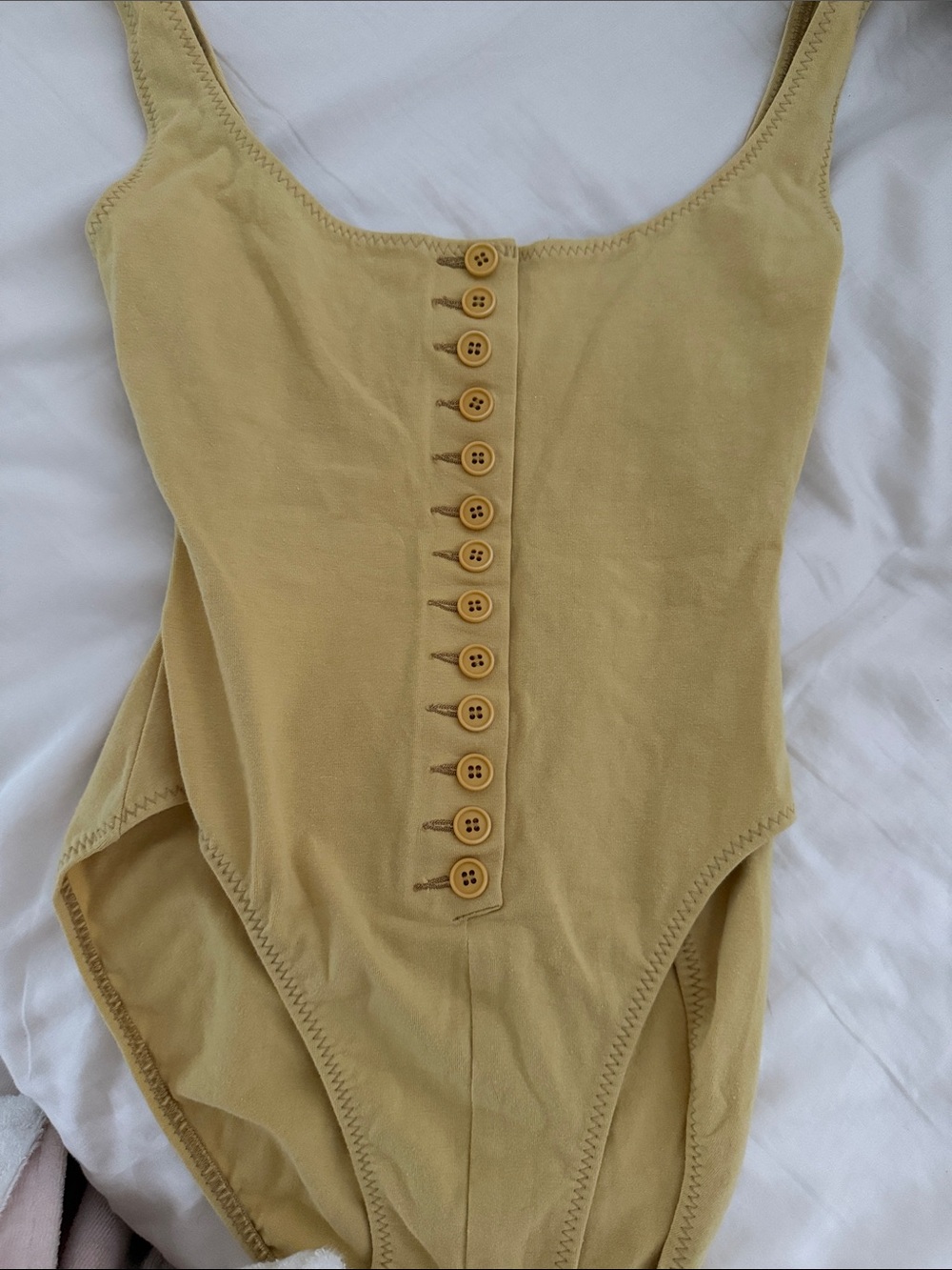 Norma Kamali , bodysuit Button-Front One-Piece in Mustard Yellow